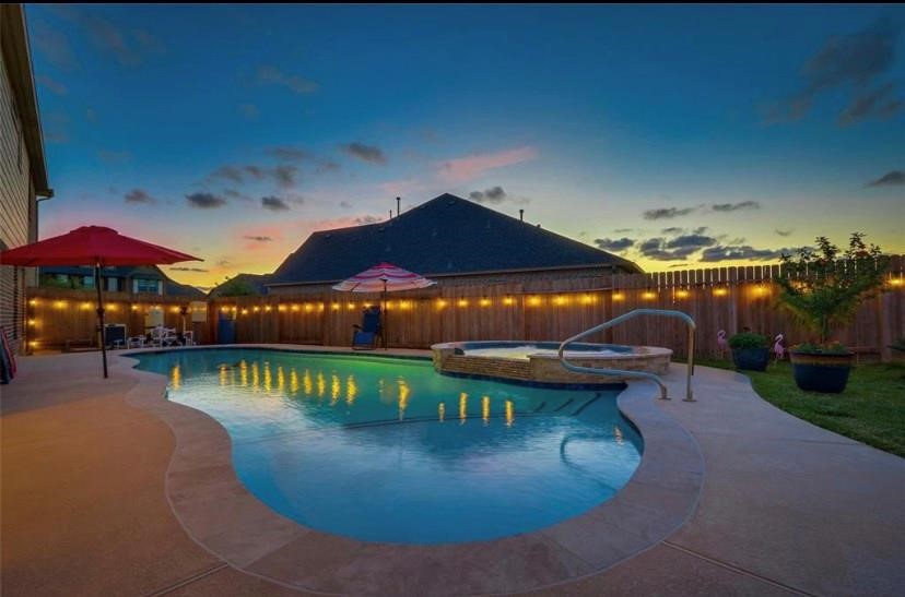 12402 Garnet Road Mont Belvieu, TX 77535 - Photo 41 of 49 a view of a swimming pool with a patio