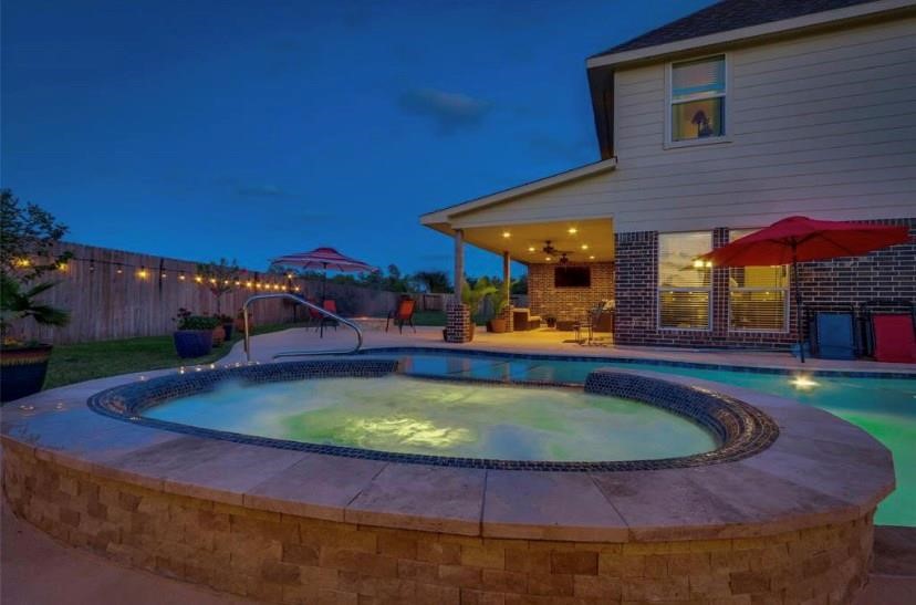 12402 Garnet Road Mont Belvieu, TX 77535 - Photo 42 of 49 a view of a swimming pool with an outdoor seating