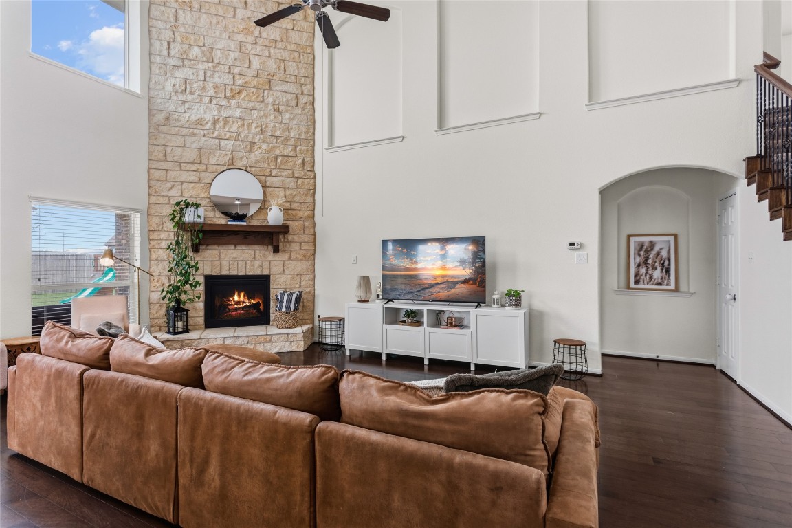 12402 Garnet Road Mont Belvieu, TX 77535 - Photo 9 of 49 a living room with furniture a flat screen tv and a fireplace