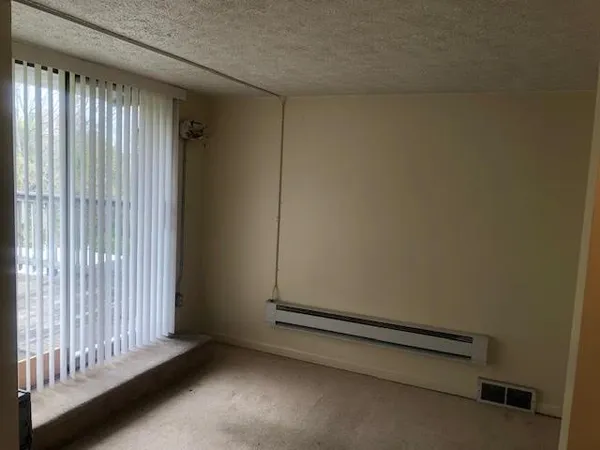 a room with water heater and a window