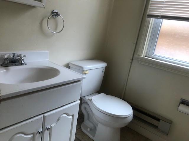 18 Haberman Avenue, Unit 2 Pittsburgh, PA 15211 - Photo 6 of 19 a white toilet sitting next to a bathroom sink