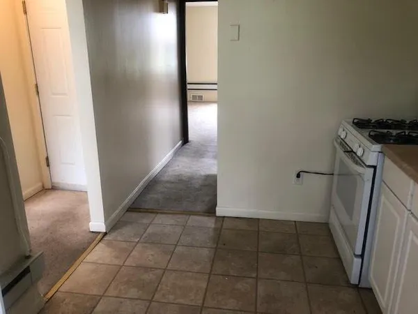 a kitchen with white cabinets and white appliances