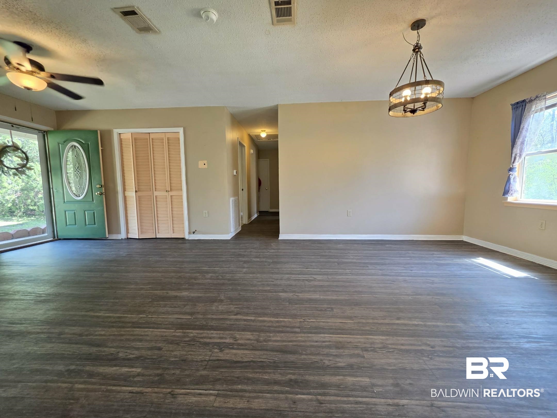 11 Coal Fire Road Jackson, AL 36545 - Photo 14 of 23 Unfurnished dining area with a textured ceiling, dark wood-type flooring, suspended lighting, and a ceiling fan