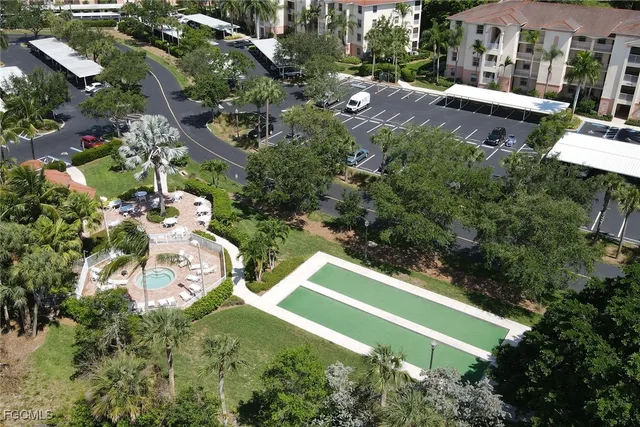 an aerial view of a house with a yard and lake view