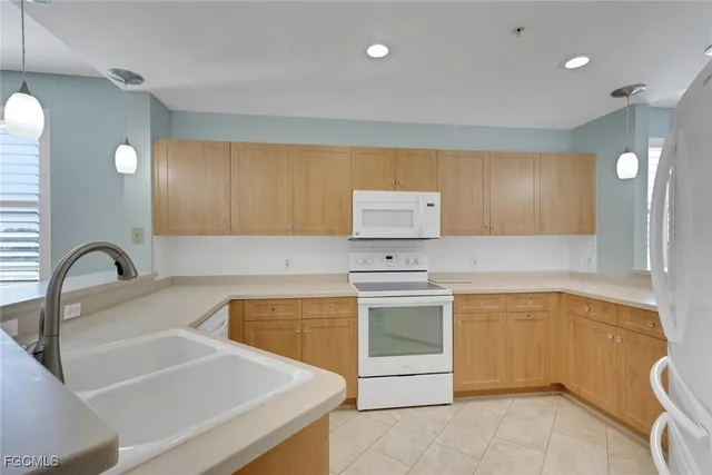 a kitchen with granite countertop a sink and a stove top oven
