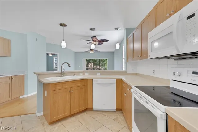a kitchen with a sink cabinets and window