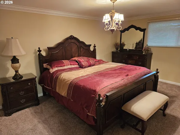 a bedroom with a bed and a chandelier