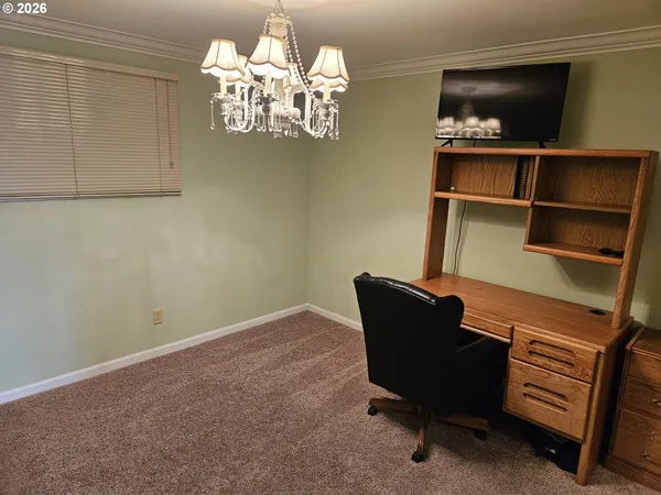 a view of a livingroom with furniture and a chandelier