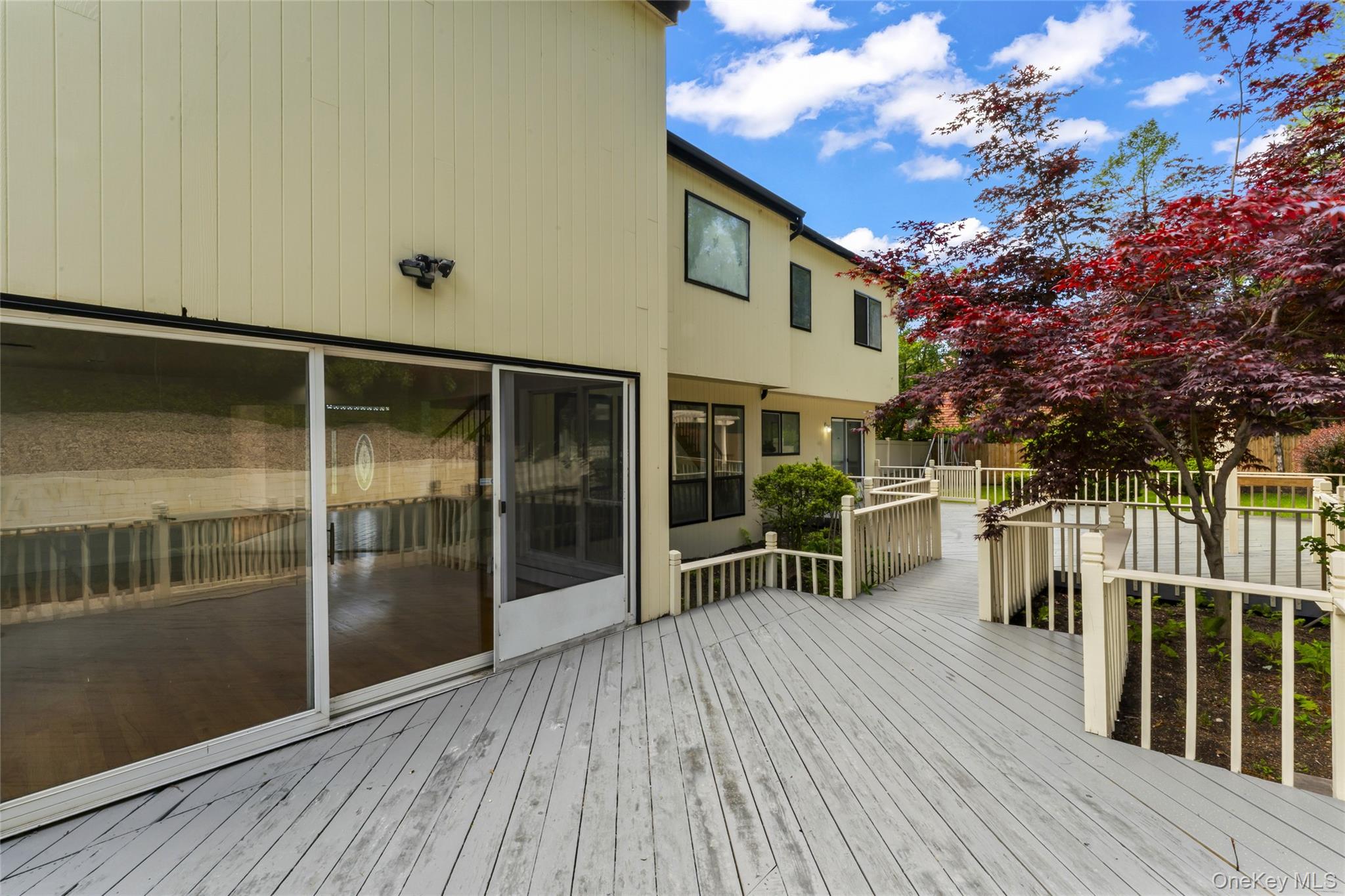 126 Bagatelle Road Melville, NY 11747 - Photo 43 of 50 a view of a house with a large window and wooden floor