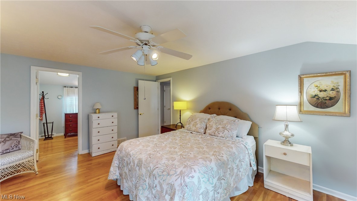 1881 Winchester Road Cleveland, OH 44124 - Photo 14 of 27 Primary bedroom w/natural hardwood floored bedroom with ceiling fan for added comfort and large dressing room attached with access to updated bathroom.