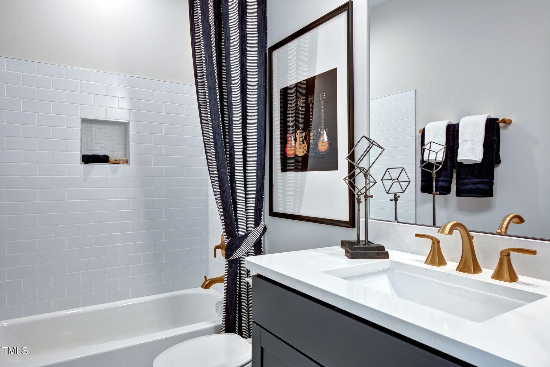 8904 Nicewonder Way Wake Forest, NC 27587 - Photo 14 of 50 a bathroom with a sink and a mirror