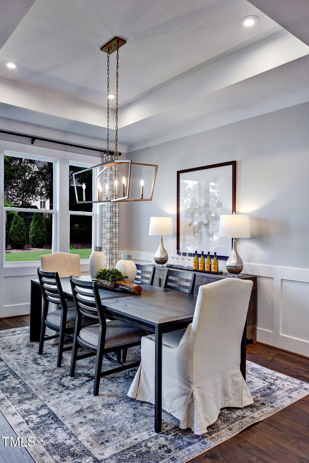 8904 Nicewonder Way Wake Forest, NC 27587 - Photo 21 of 50 a dining room with furniture a chandelier and window