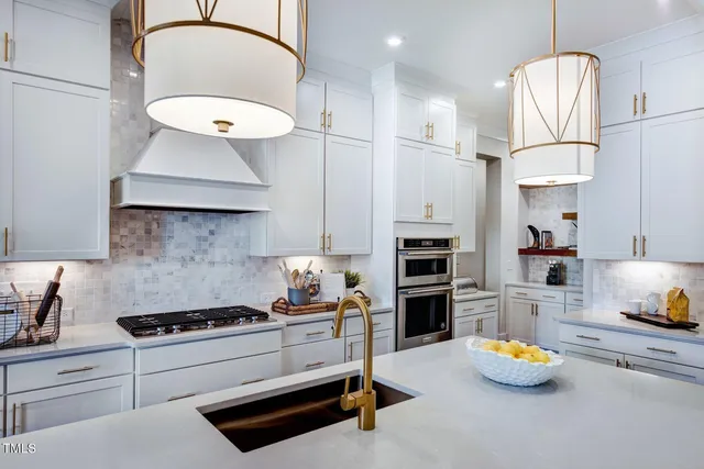 a kitchen with a sink a stove and chairs