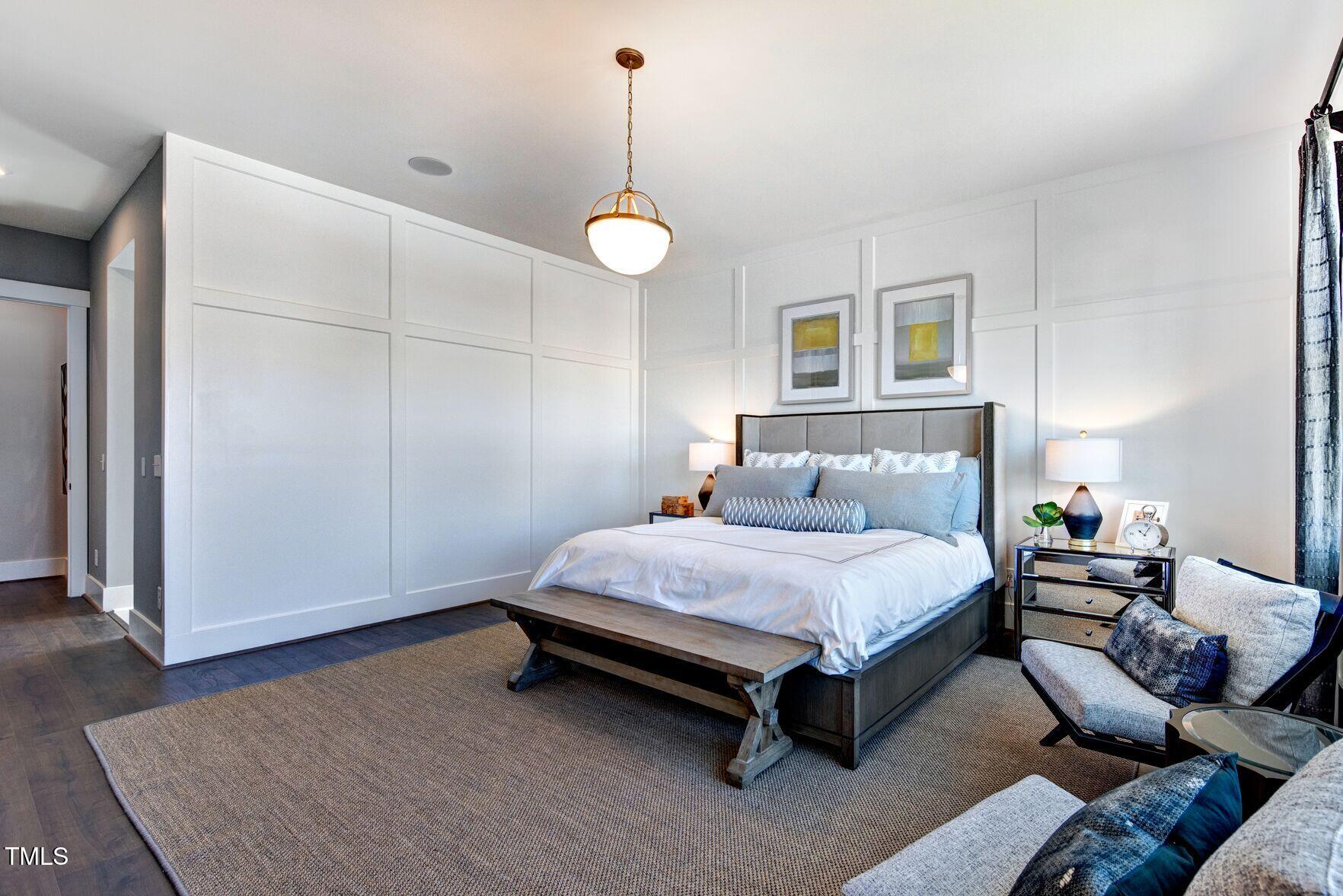 8904 Nicewonder Way Wake Forest, NC 27587 - Photo 49 of 50 a spacious bedroom with a bed and a couch