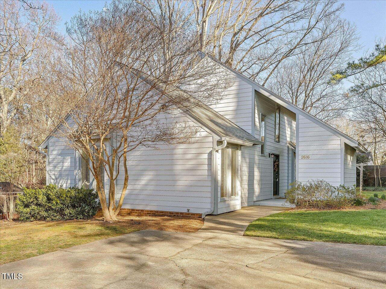 2616 Catalina Drive Raleigh, NC 27607 - Photo 1 of 60 a view of a house with a yard and large tree