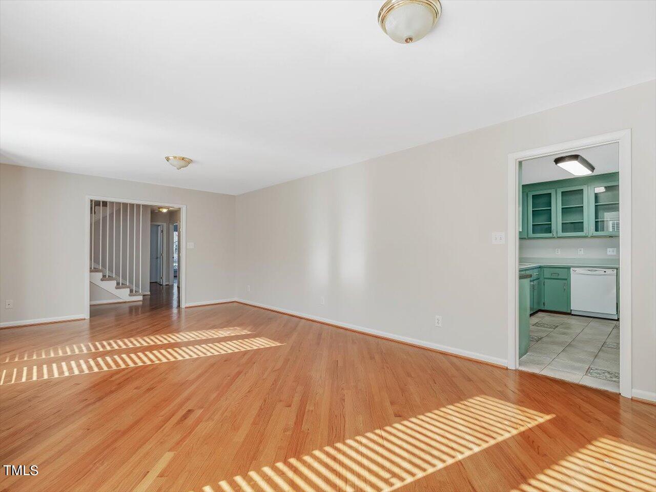 2616 Catalina Drive Raleigh, NC 27607 - Photo 11 of 60 a view of an empty room with wooden floor and a window
