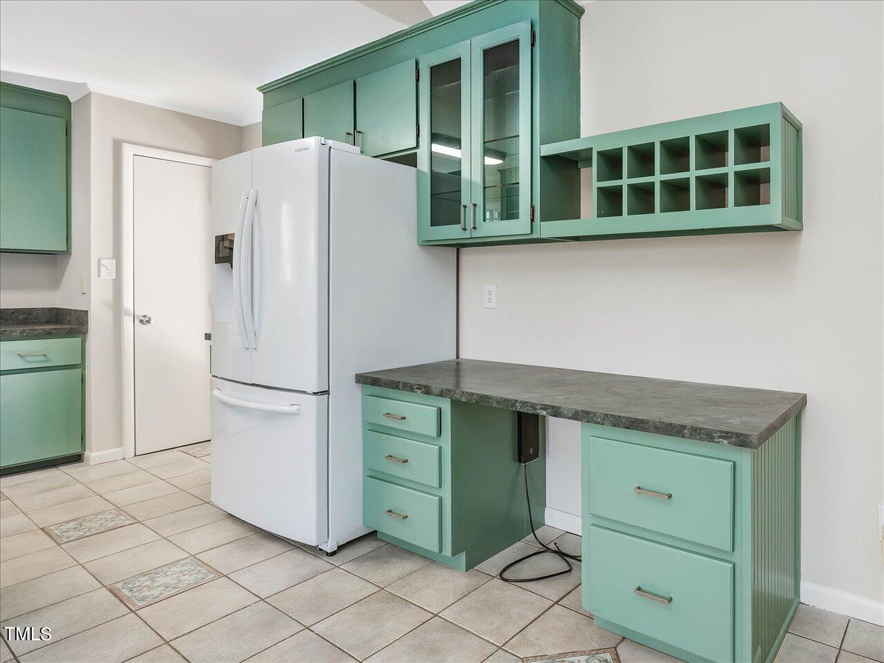 2616 Catalina Drive Raleigh, NC 27607 - Photo 19 of 60 a kitchen with a refrigerator and cabinets