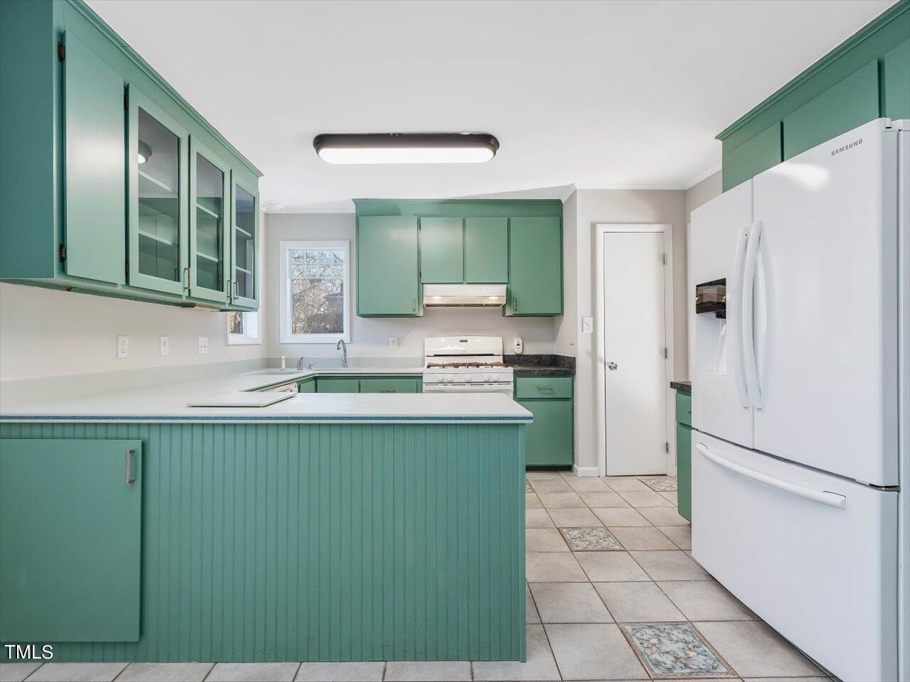 2616 Catalina Drive Raleigh, NC 27607 - Photo 20 of 60 a kitchen with stainless steel appliances granite countertop a refrigerator and a sink