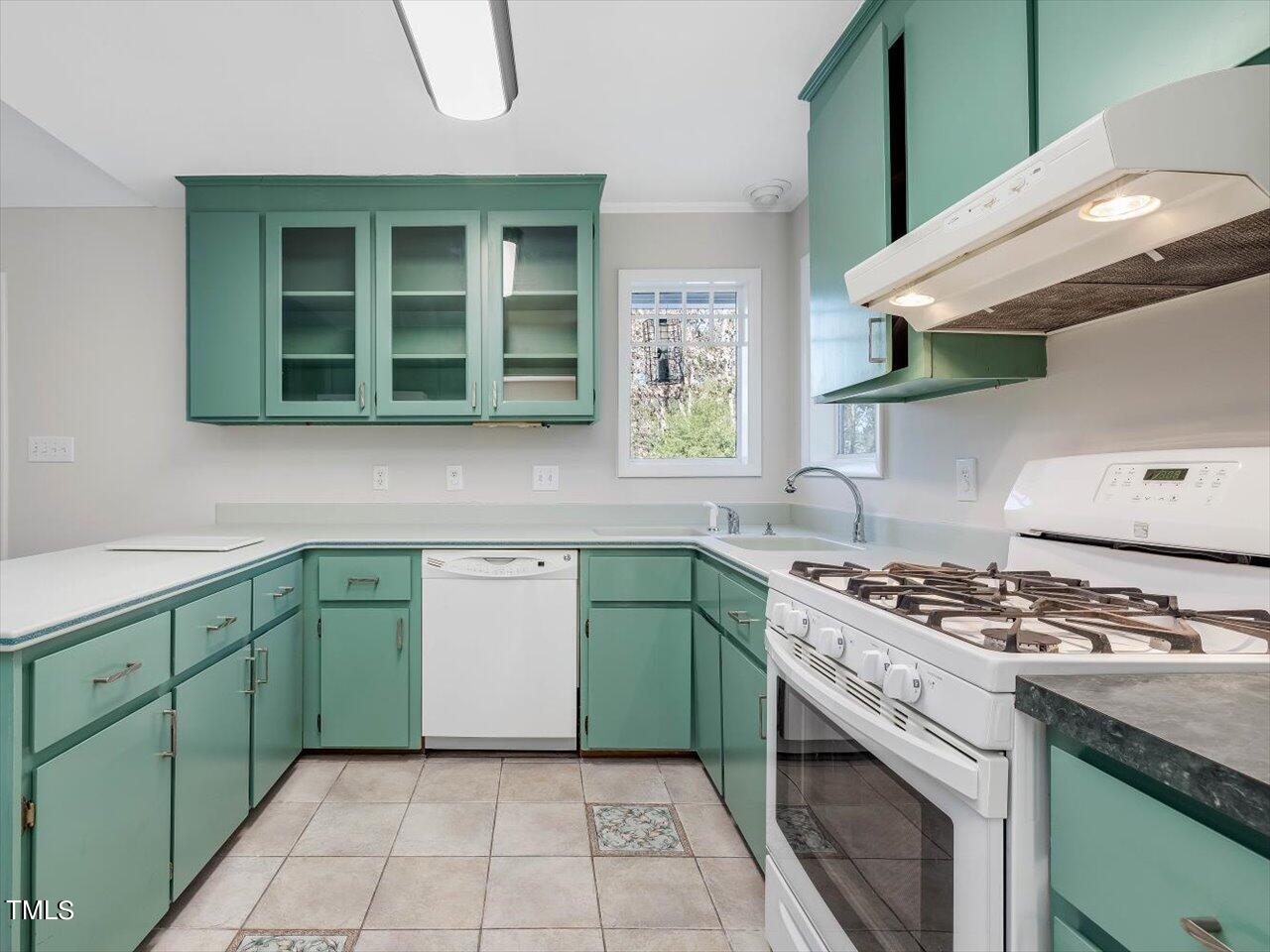 2616 Catalina Drive Raleigh, NC 27607 - Photo 21 of 60 a kitchen with a stove sink and cabinets