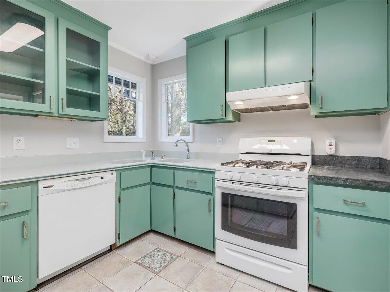 2616 Catalina Drive Raleigh, NC 27607 - Photo 22 of 60 a kitchen with cabinets a washer and dryer