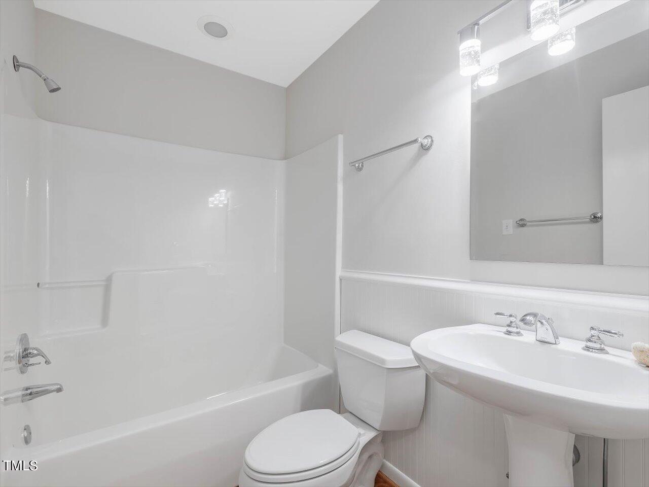 2616 Catalina Drive Raleigh, NC 27607 - Photo 32 of 60 a bathroom with a toilet a sink a mirror a bathtub and vanity