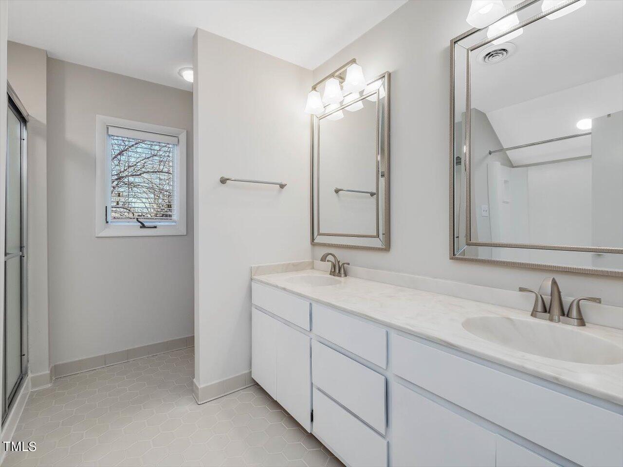 2616 Catalina Drive Raleigh, NC 27607 - Photo 39 of 60 a bathroom with double sink and a mirror