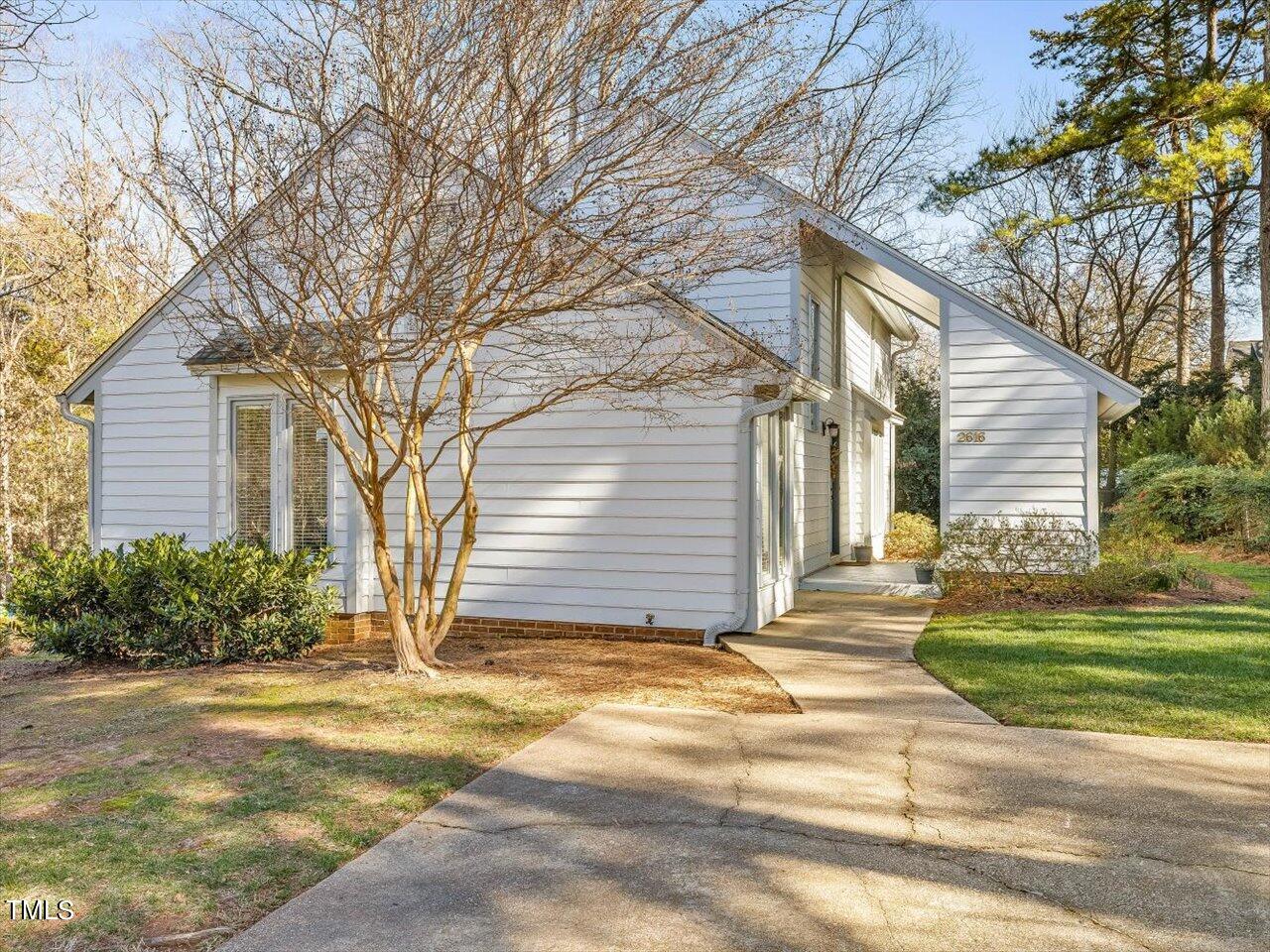 2616 Catalina Drive Raleigh, NC 27607 - Photo 4 of 60 a view of a house with a yard and garage