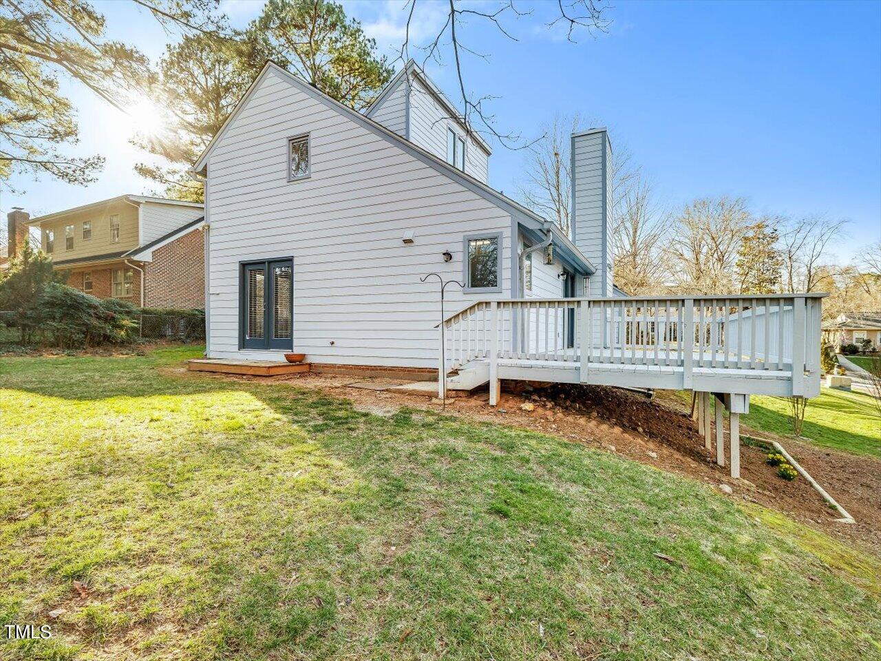 2616 Catalina Drive Raleigh, NC 27607 - Photo 54 of 60 a view of a house with wooden deck and a backyard
