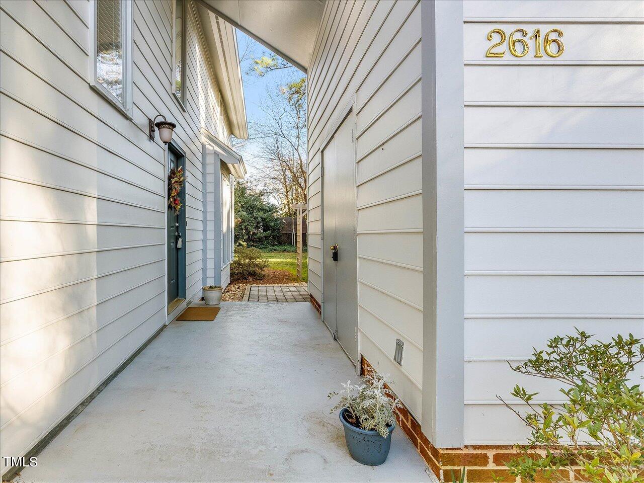 2616 Catalina Drive Raleigh, NC 27607 - Photo 6 of 60 a view of a street with a potted plant on both side of a building