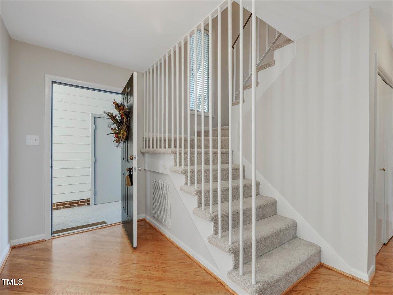 2616 Catalina Drive Raleigh, NC 27607 - Photo 9 of 60 a view of staircase with white walls and windows