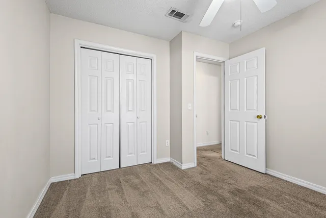 an empty room with closet area
