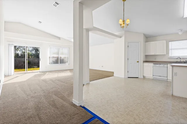 a view of an empty room with window and cabinet