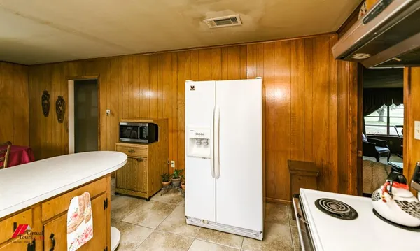 a kitchen with a refrigerator sink and stove top oven