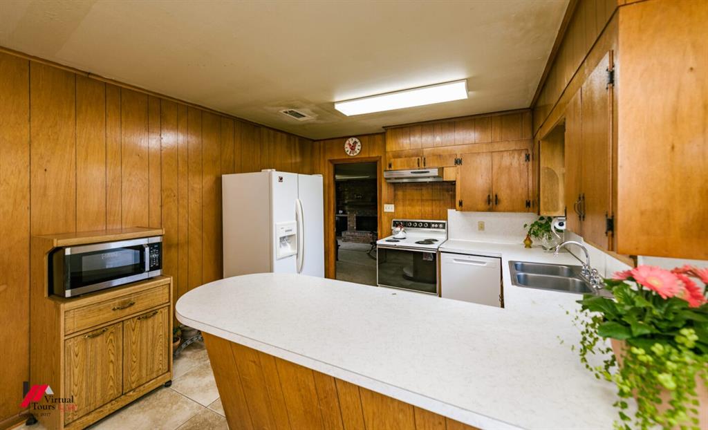 6103 Colquitt Road Keithville, LA 71047 - Photo 16 of 34 a kitchen with a refrigerator sink and stove top oven