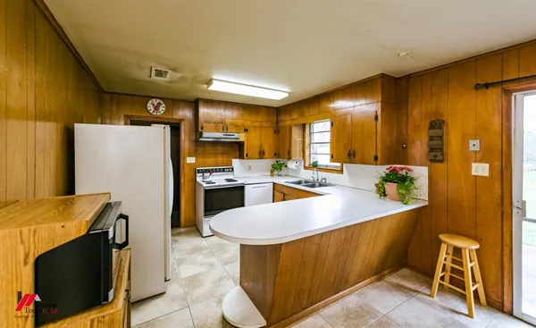 a bathroom with a granite countertop sink a toilet a mirror and shower