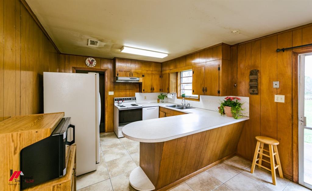 6103 Colquitt Road Keithville, LA 71047 - Photo 19 of 34 a kitchen with stainless steel appliances granite countertop a sink a stove and refrigerator