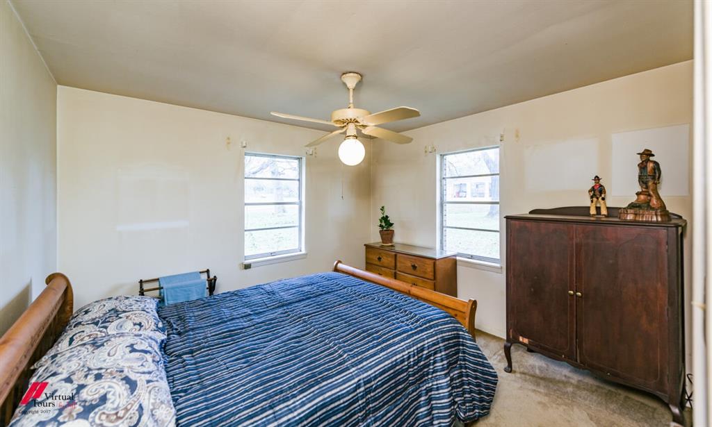 6103 Colquitt Road Keithville, LA 71047 - Photo 23 of 34 a bed room with a bed and a chandelier