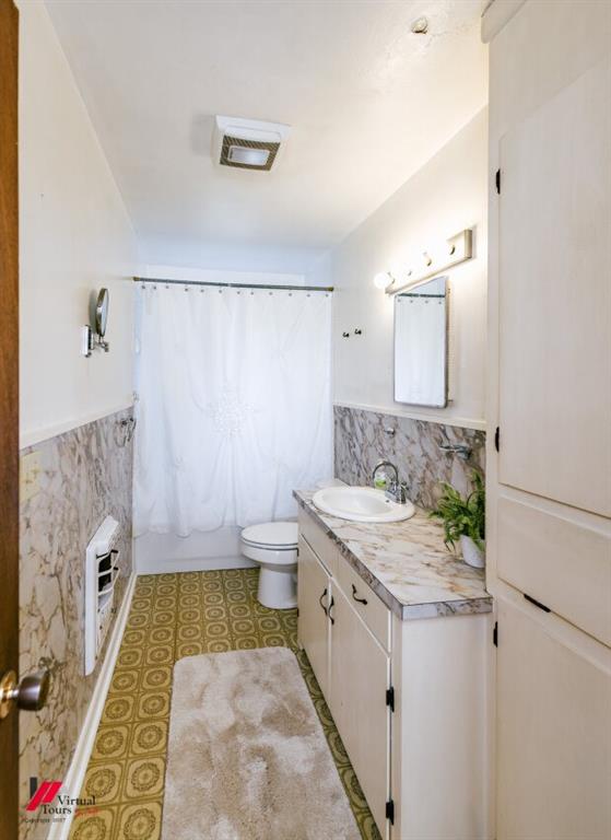 6103 Colquitt Road Keithville, LA 71047 - Photo 24 of 34 a bathroom with a granite countertop sink a toilet a mirror and shower