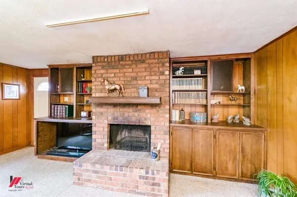 a living room with furniture a fireplace and city view