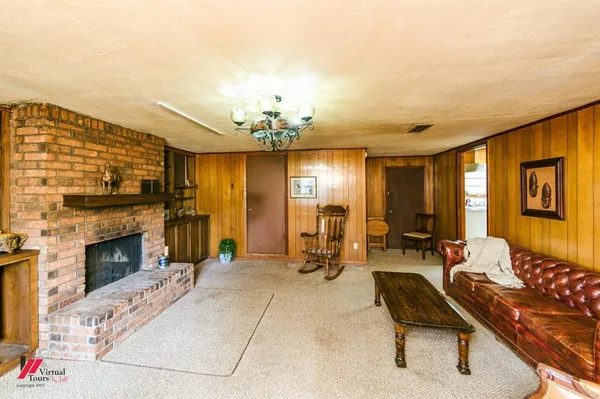 a living room with furniture a chandelier and a window
