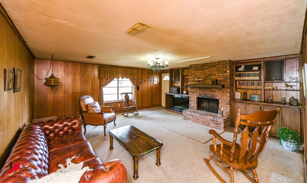 6103 Colquitt Road Keithville, LA 71047 - Photo 6 of 34 a living room with furniture a fireplace and a flat screen tv