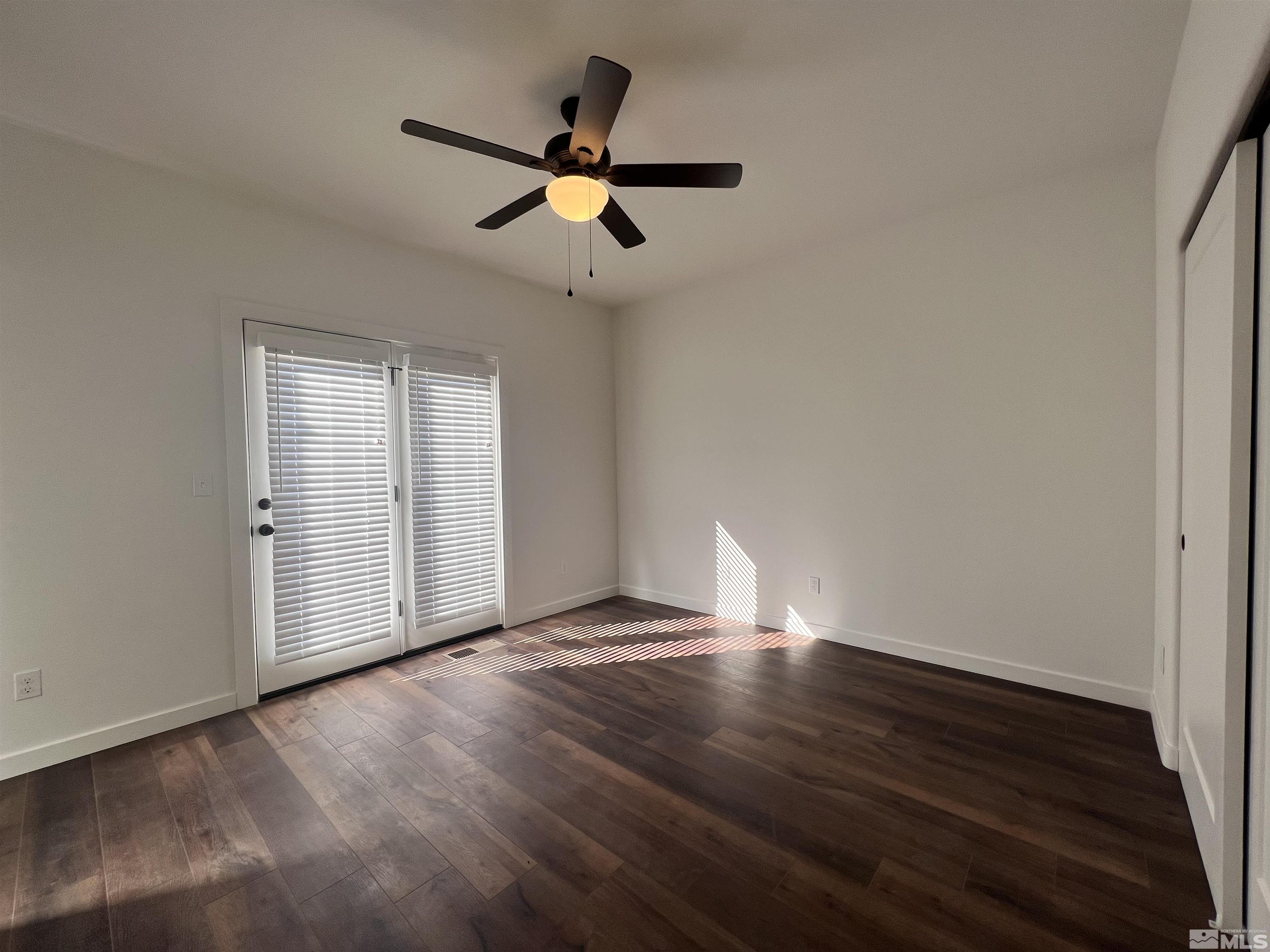 682 Silver Spur Drive Fallon, NV 89406 - Photo 14 of 29 a view of an empty room with wooden floor and a window