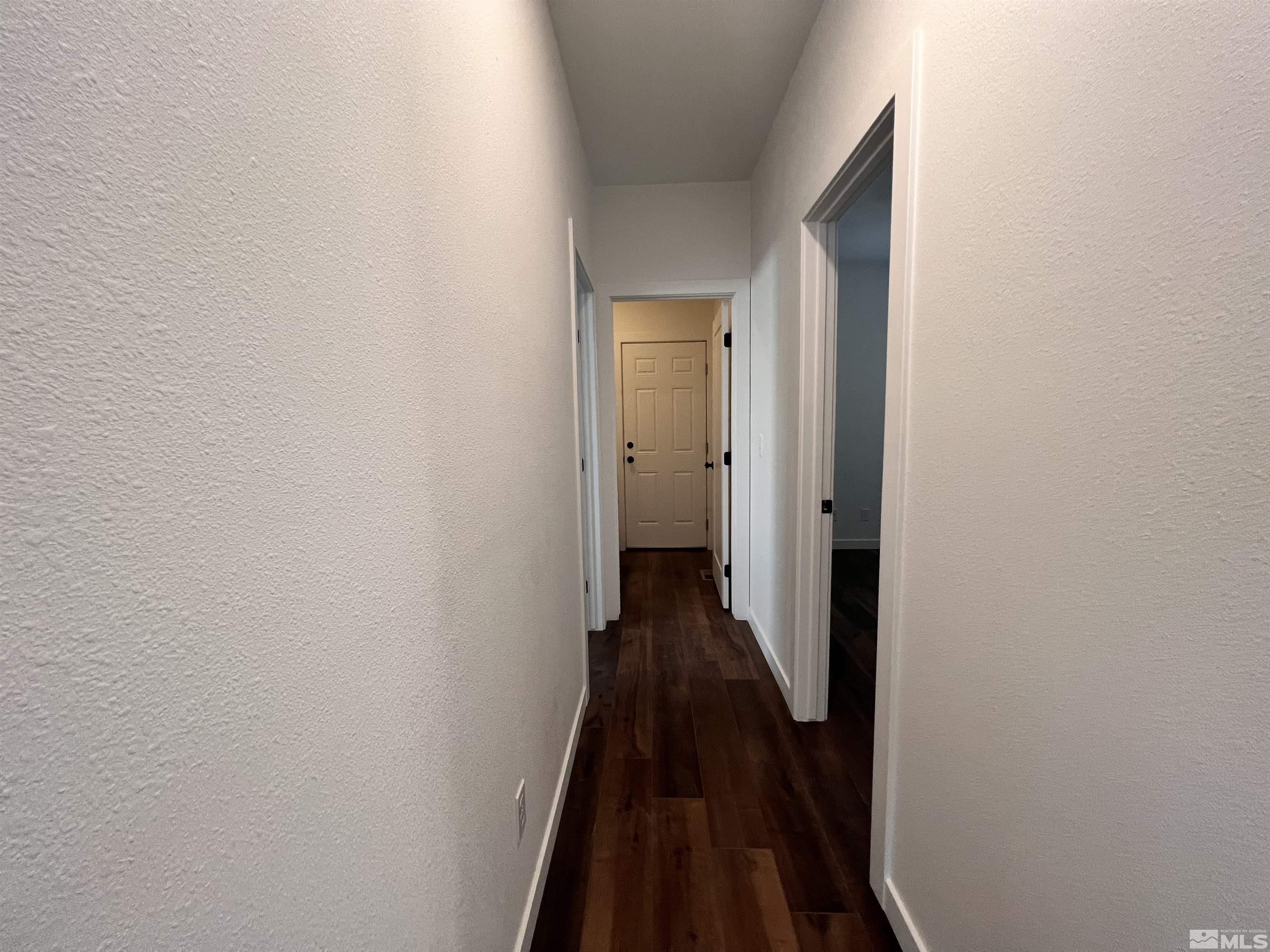 682 Silver Spur Drive Fallon, NV 89406 - Photo 16 of 29 a view of a hallway with wooden floor and a bathroom