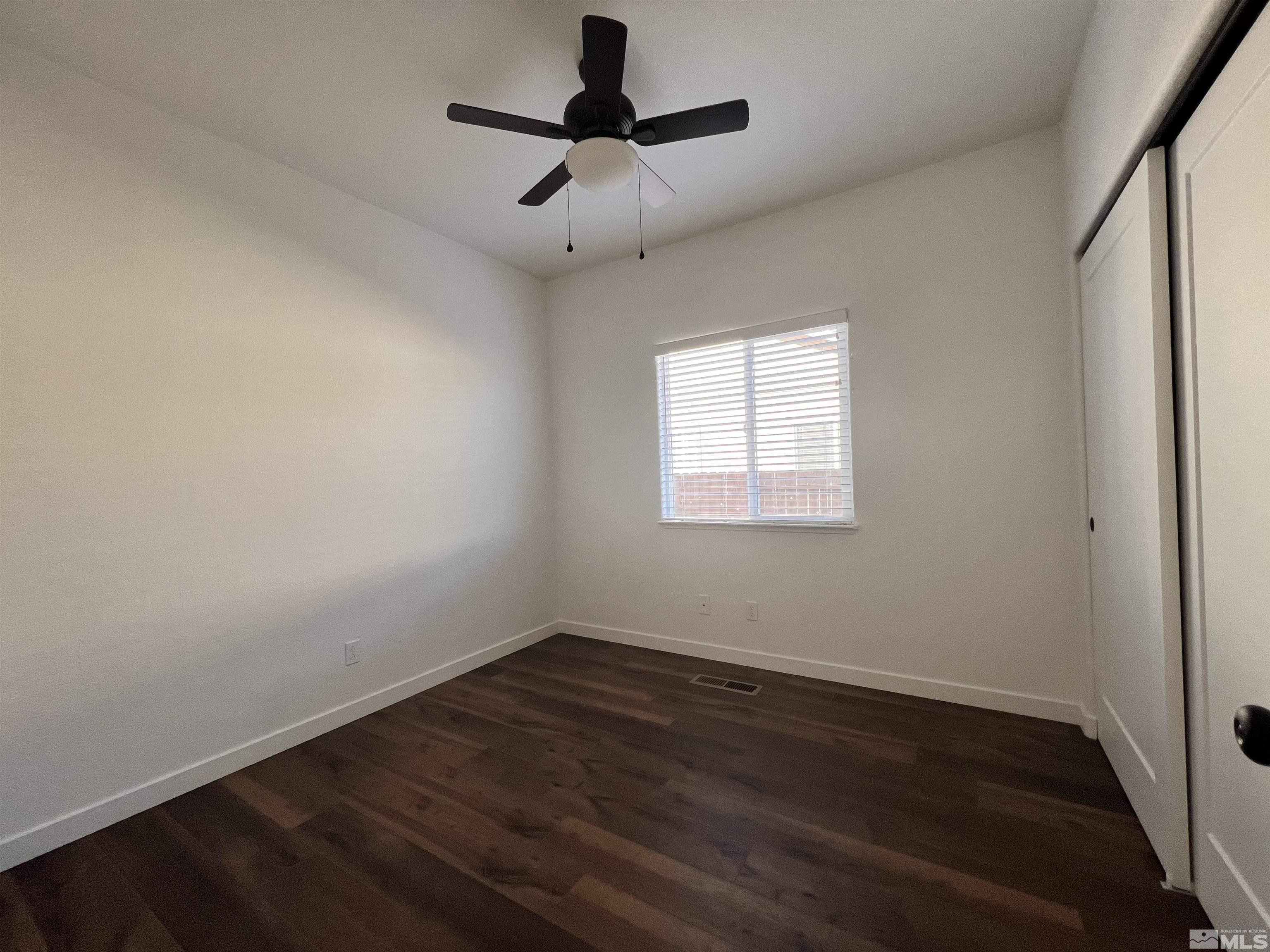 682 Silver Spur Drive Fallon, NV 89406 - Photo 17 of 29 wooden floor in an empty room with a window