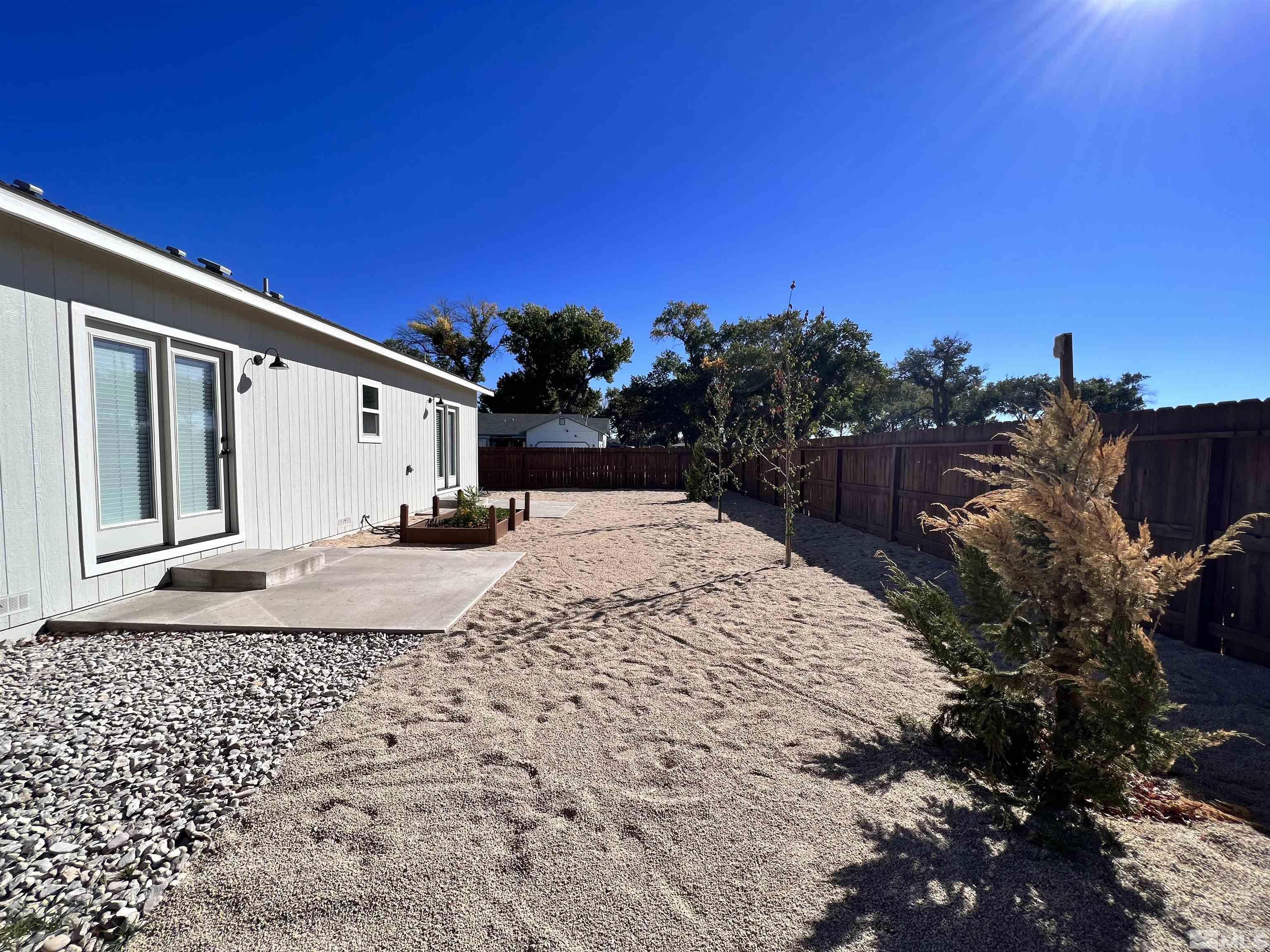 682 Silver Spur Drive Fallon, NV 89406 - Photo 26 of 29 a view of a white house with a yard