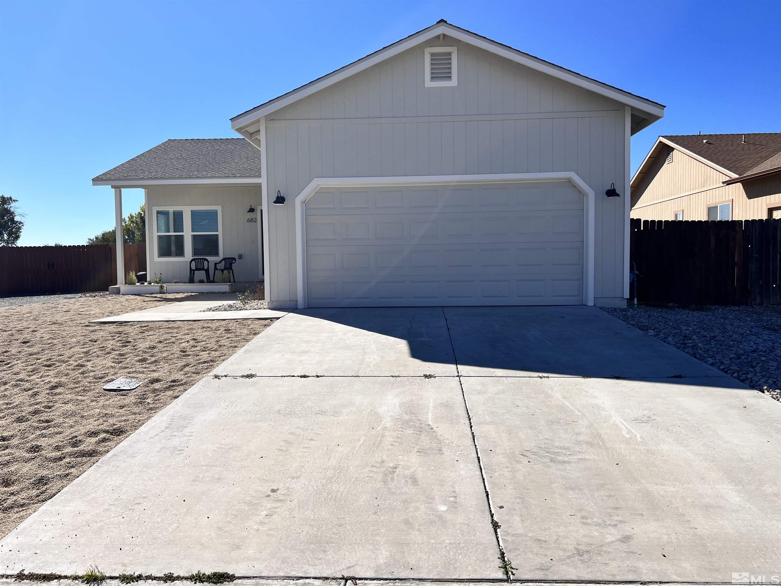 682 Silver Spur Drive Fallon, NV 89406 - Photo 3 of 29 a front view of a house with yard