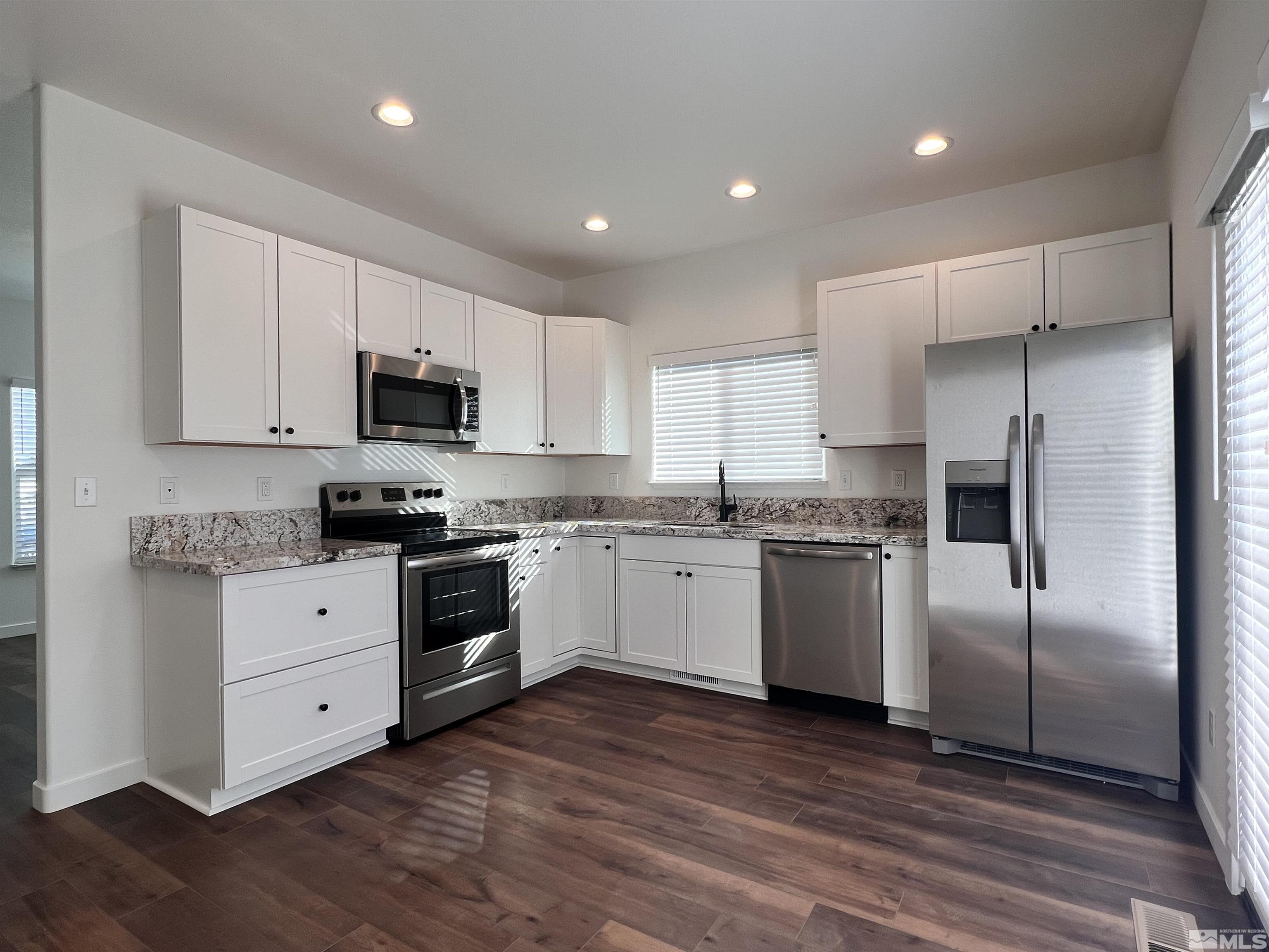 682 Silver Spur Drive Fallon, NV 89406 - Photo 8 of 29 a kitchen with stainless steel appliances cabinets a sink and a microwave