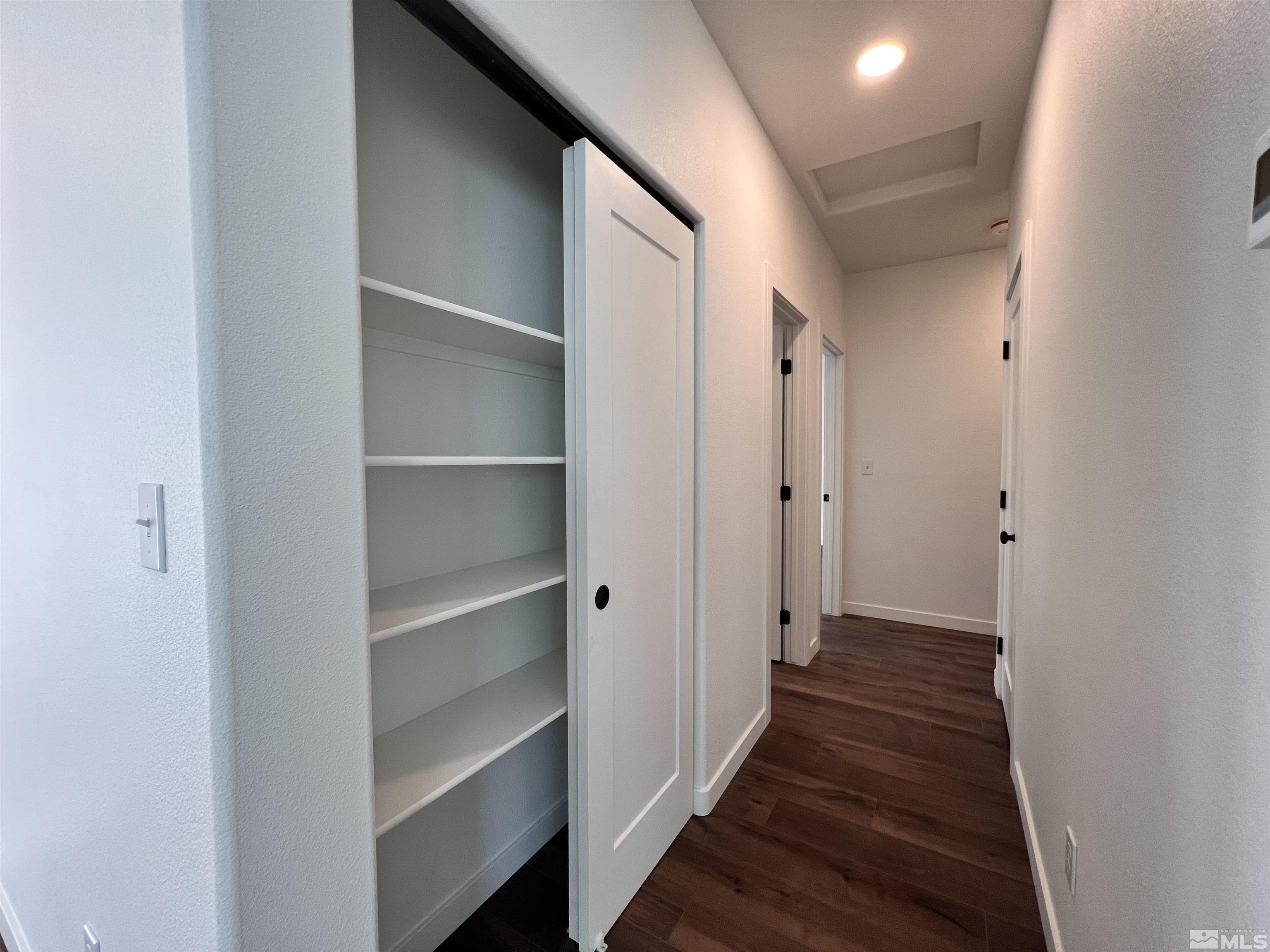 682 Silver Spur Drive Fallon, NV 89406 - Photo 10 of 29 a view of a hallway with wooden floor and closet