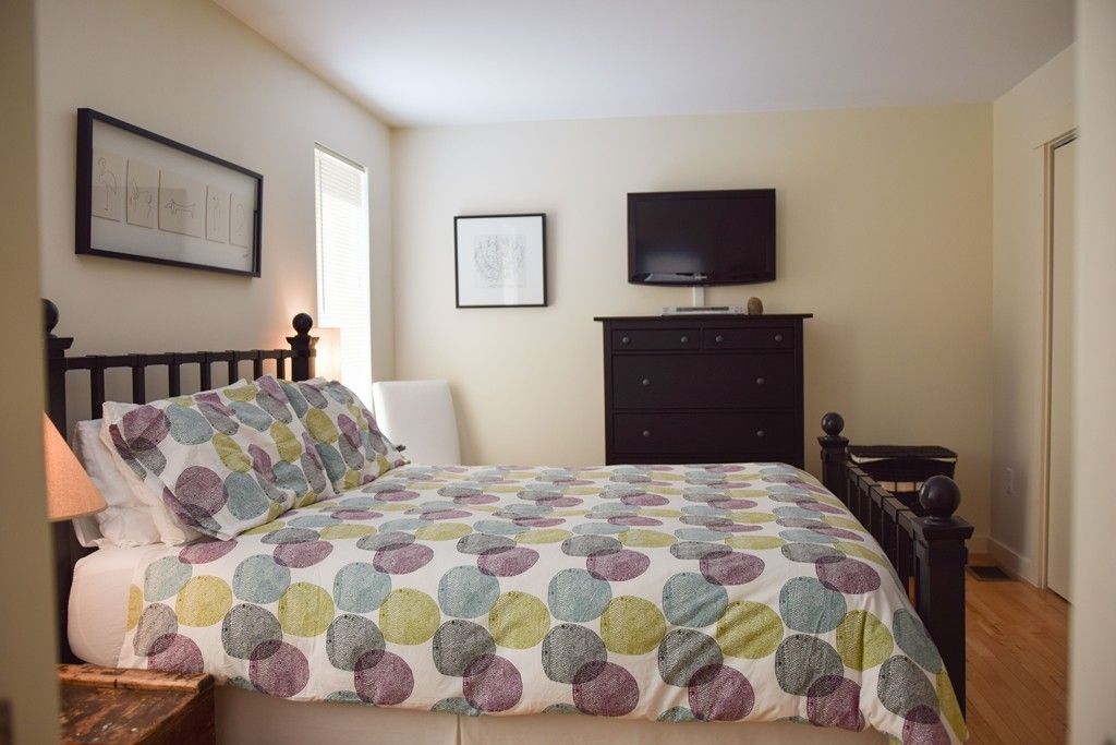 80 Rindge Turnpike Ashburnham, MA 01430 - Photo 26 of 30 a bedroom with a bed and a flat screen tv