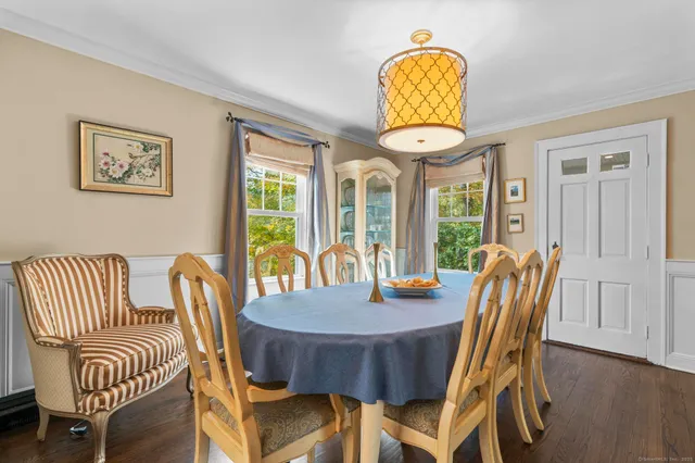 a view of a dining room with furniture wooden floor and chandelier